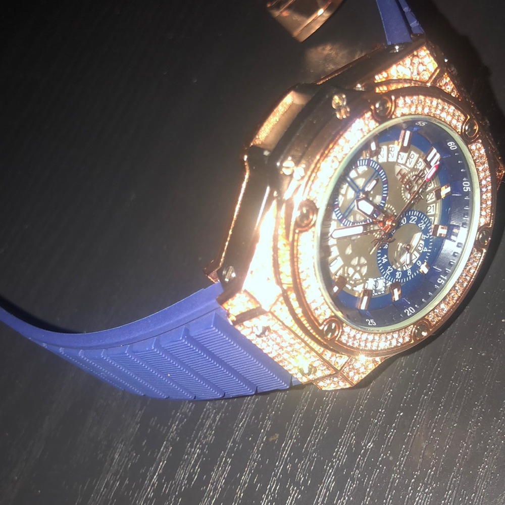Iced out rose gold Hublot watch with blue band